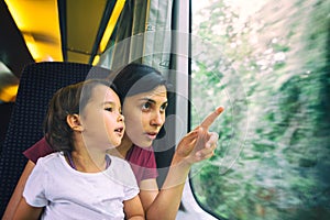 Mother and her daughter enjoing the train trip photo