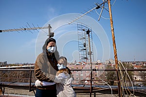 Mother with her daughter have medical gloves and masks, they are worry