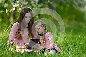 mom and daughter looking at a tablet