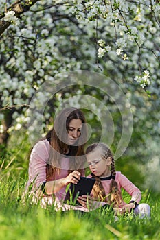 mom and daughter looking at a tablet