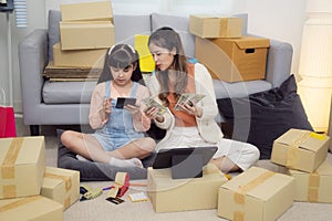 Mother and her daughter packing and sell online togather at home