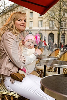 Mother and her daughter in Parisian street cafe
