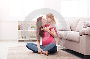 Mother and her daughter playing and hugging.