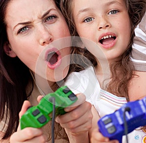 Mother and her daughter playing video games