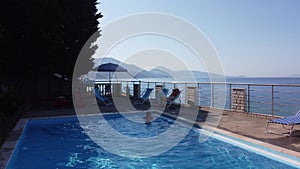 Mother and her daughter relaxing in hotel swimming pool. People enjoying vacation. Mother daughter realtionship.