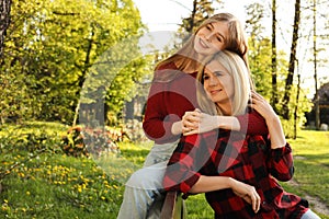 Mother with her daughter spending time together in park on sunny day