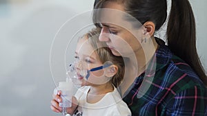 Mother and her Daughter Taking Inhalation Therapy