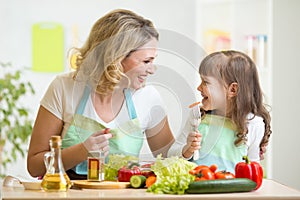 Mother and her kid preparing healthy food and
