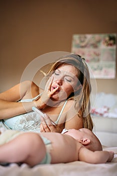 Mother with her little baby boy at home. Worried mother checks