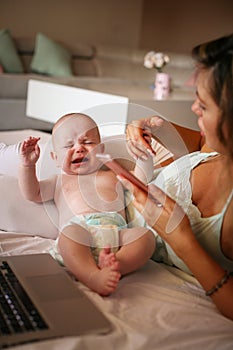 Mother and her little baby at home.