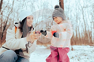 Mother and her Little Daughter Exchanging Christmas Gifts