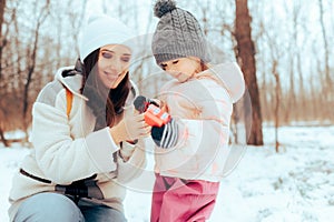 Mother and her Little Daughter Exchanging Christmas Gifts