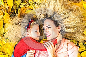 Mother with her little daughter have fun in the park.