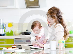 Mother and her little daughter with tablet pc