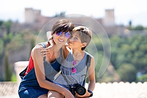 Mother and her little daughter traveling together in urban background.