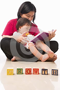 Mother and her little girl reading book