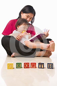 Mother and her little girl reading book