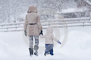 Mother with her little girl in snow