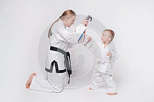 Mother her little son practicing martial arts over white background