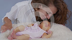 Mother and her Newborn Baby. Happy Mother holding her New born Baby girl kissing and hugging. Maternity concept