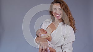 Mother and her Newborn Baby. Happy Mother holding her New born Baby girl kissing and hugging. Maternity concept