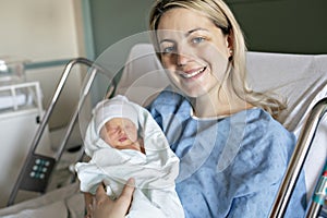 Mother with her newborn baby at the hospital a day after a natural birth labor