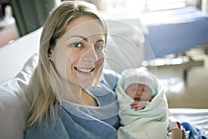 Mother with her newborn baby at the hospital a day after a natural birth labor