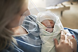 Mother with her newborn baby at the hospital a day after a natural birth labor