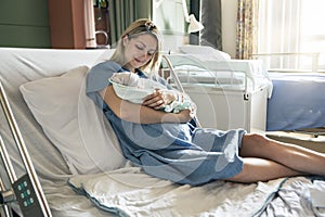 Mother with her newborn baby at the hospital a day after a natural birth labor