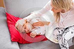 Mother with her sick kid at home