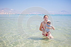 Mother and her son have fun in the sea in summertime