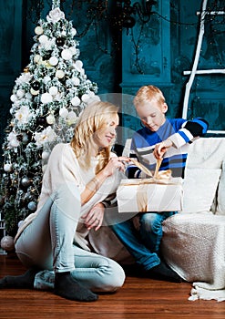 Mother and her son at home with a Christmas tree