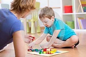 Mother and her son playing in board game