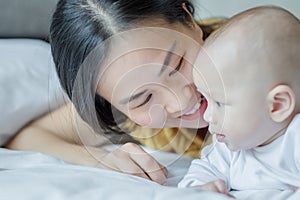 Mother and her son reading book in a bed before sleep. Familly story telling concept