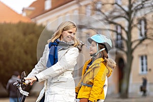 Mother and her son riding the bicycle in a city