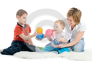 Mother with her sons enjoy with colorful balls