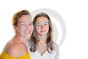 Mother with her teenage daughter hugging and laughing in white background