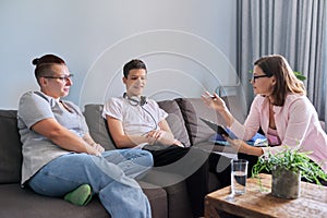 Mother with her teenage son at meeting with social worker, psychologist