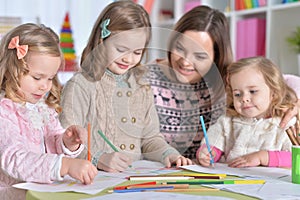 Mother and her three daughters drawing