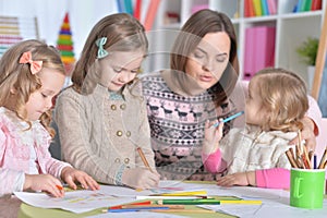 Mother and her three daughters drawing together