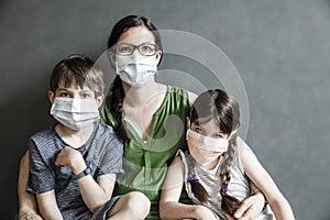 Mother and her two children wearing masks