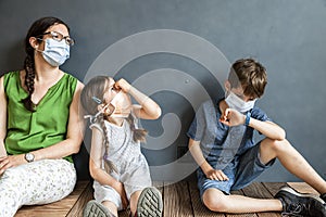 Mother and her two children wearing masks