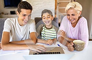 Mother with her two sons using laptop