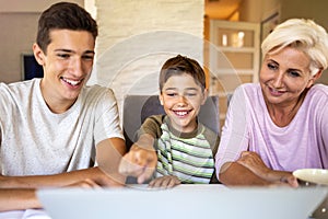 Mother with her two sons using laptop