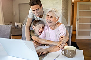 Mother with her two sons using laptop