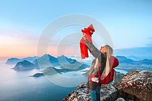 Mother hiking with baby outdoor family vacations in Norway travel in Lofoten islands active healthy lifestyle