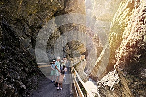 Mother hikking with four kids in Liechtensteinklamm or Liechtenstein Gorge, Austria