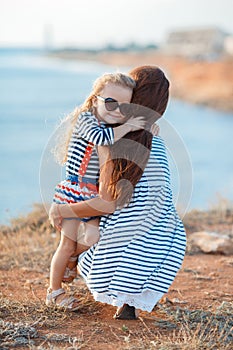 Mother and his adorable little daughter at beach