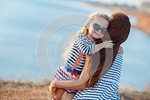 Mother and his adorable little daughter at beach