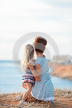 Mother and his adorable little daughter at beach
